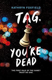 Book cover for TAG YOU'RE DEAD: title in white on black around a chess piece dripping blood